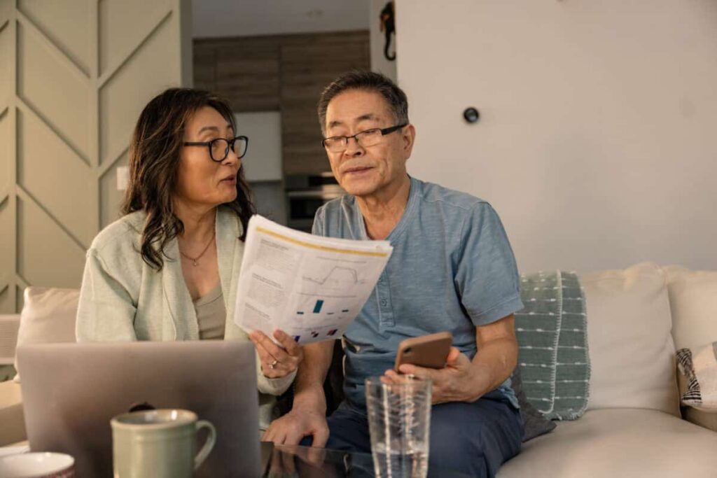 senior couple looks at investing statements